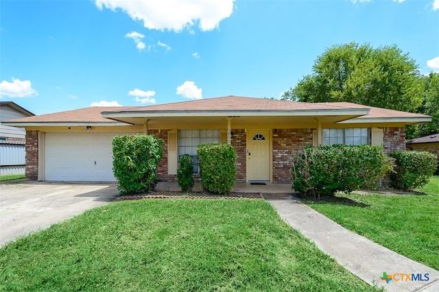 view of front of property featuring a garage and a front yard