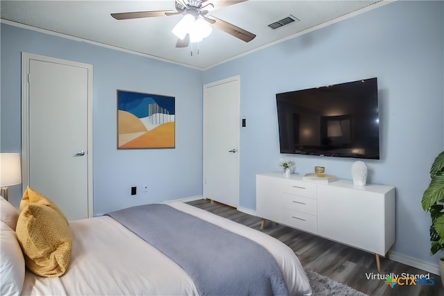 bedroom with dark wood-type flooring, ceiling fan, and crown molding