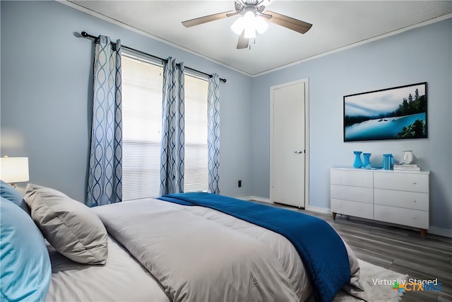 bedroom featuring crown molding, hardwood / wood-style flooring, and ceiling fan