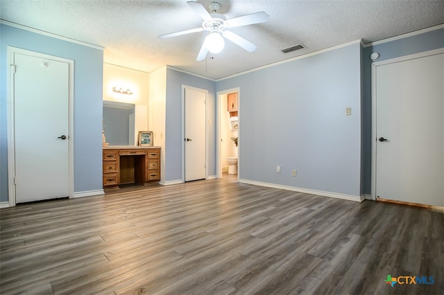 unfurnished bedroom with hardwood / wood-style flooring, ceiling fan, connected bathroom, and a textured ceiling