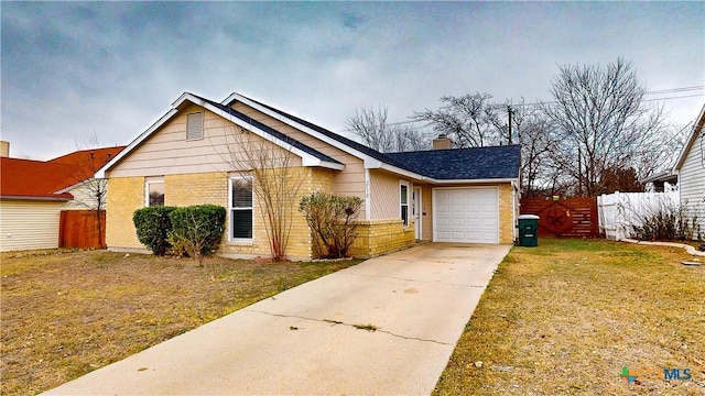 view of front of property with a front lawn and a garage