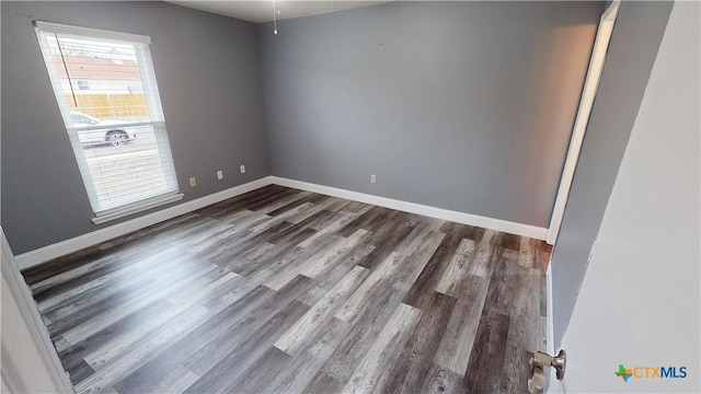 unfurnished room featuring dark hardwood / wood-style floors