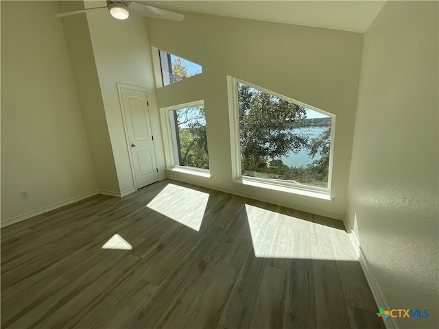 interior space featuring light wood-type flooring, plenty of natural light, ceiling fan, and high vaulted ceiling