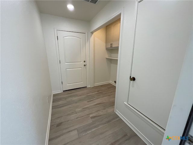 corridor with light hardwood / wood-style flooring