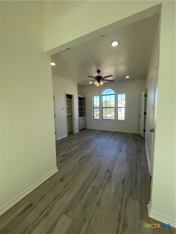 unfurnished living room featuring wood-type flooring and ceiling fan