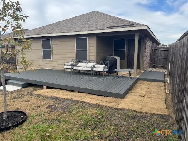 back of property with an outdoor hangout area and a deck