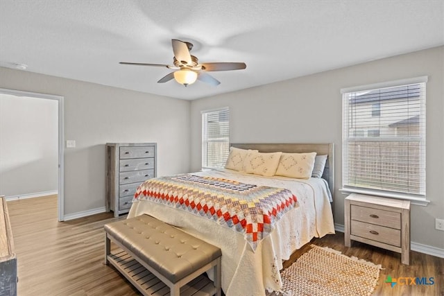 bedroom with hardwood / wood-style flooring and ceiling fan