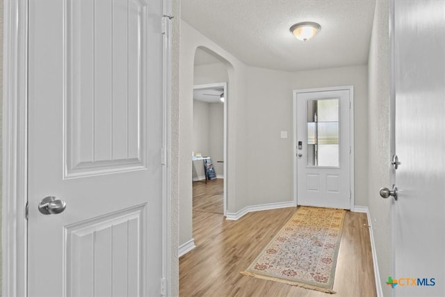 entrance foyer featuring a textured ceiling and light wood-type flooring