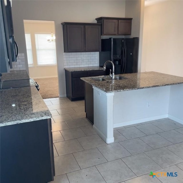 3805 Flat Rock Mountain Dr, Killeen, TX 76549 - kitchen featuring a sink, baseboards, black refrigerator with ice dispenser, and light stone countertops