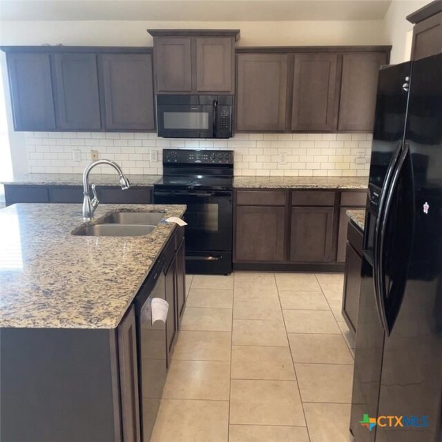 3805 Flat Rock Mountain Dr, Killeen, TX 76549 - kitchen with light stone countertops, a sink, black appliances, and decorative backsplash