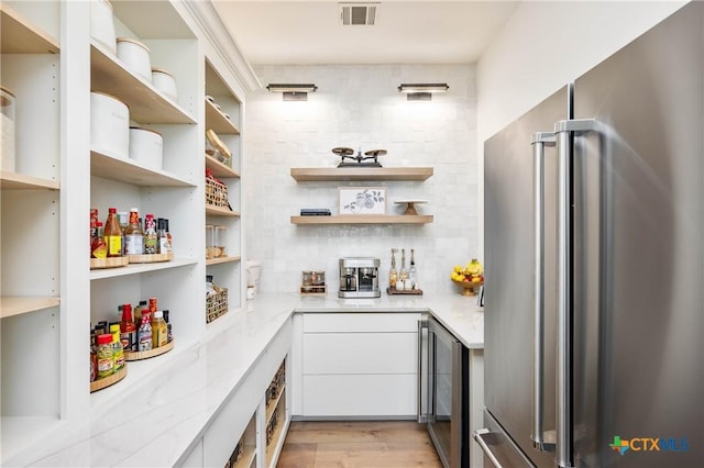 pantry with visible vents and beverage cooler