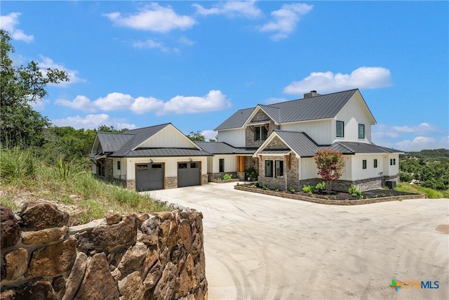 modern farmhouse with metal roof, stone siding, and a standing seam roof