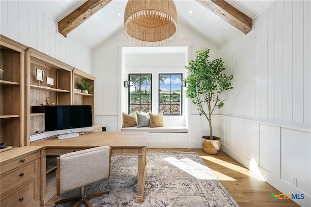 home office with lofted ceiling with beams, wood finished floors, and a decorative wall