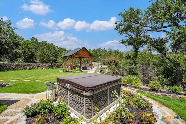 view of outdoor structure featuring a gazebo and a hot tub