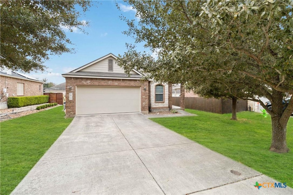 view of front of property featuring a front yard and a garage