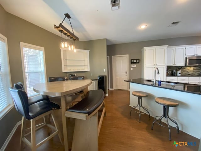 406 Windy Way Dr, Victoria, TX 77904 - dining room with dark wood-style flooring and recessed lighting