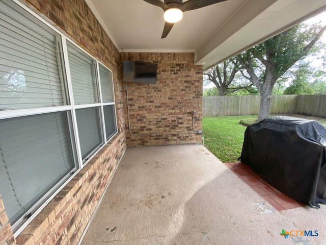 406 Windy Way Dr, Victoria, TX 77904 - fenced backyard featuring area for grilling, ceiling fan, and a patio