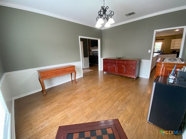 406 Windy Way Dr, Victoria, TX 77904 - dining area with a wainscoted wall, a chandelier, wood finished floors, and ornamental molding