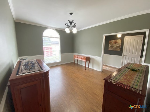 406 Windy Way Dr, Victoria, TX 77904 - bedroom featuring crown molding, a chandelier, wood finished floors, and a wainscoted wall