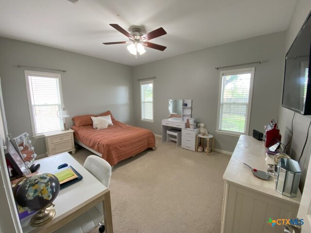 406 Windy Way Dr, Victoria, TX 77904 - bedroom with multiple windows, light colored carpet, and ceiling fan