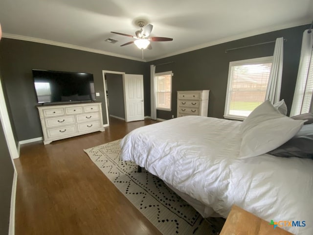 406 Windy Way Dr, Victoria, TX 77904 - bedroom with dark wood-style flooring, crown molding, and a ceiling fan
