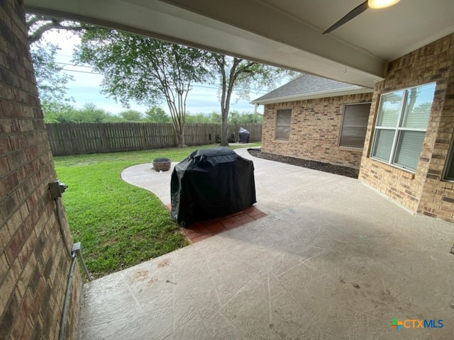 406 Windy Way Dr, Victoria, TX 77904 - fenced backyard featuring an outdoor fire pit, a grill, and a patio area