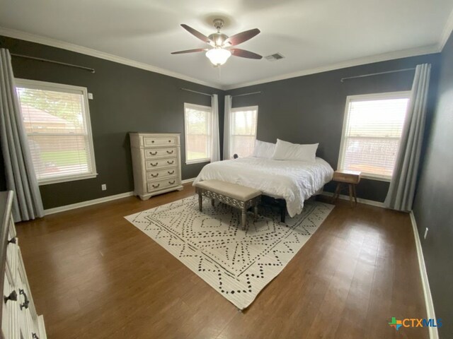 406 Windy Way Dr, Victoria, TX 77904 - bedroom featuring wood finished floors, multiple windows, ornamental molding, and ceiling fan