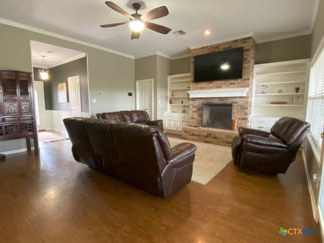 406 Windy Way Dr, Victoria, TX 77904 - living room with a ceiling fan, wood finished floors, ornamental molding, and a brick fireplace