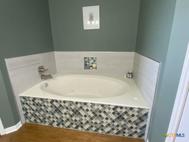 406 Windy Way Dr, Victoria, TX 77904 - bathroom with a whirlpool tub and wood finished floors