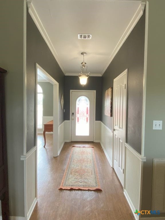 406 Windy Way Dr, Victoria, TX 77904 - entrance foyer with ornamental molding, a wainscoted wall, and wood finished floors