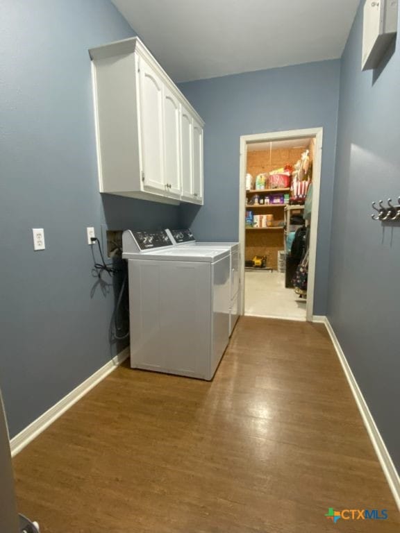 406 Windy Way Dr, Victoria, TX 77904 - laundry room with cabinet space, wood finished floors, and separate washer and dryer