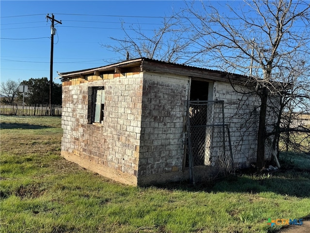 view of outbuilding with a lawn