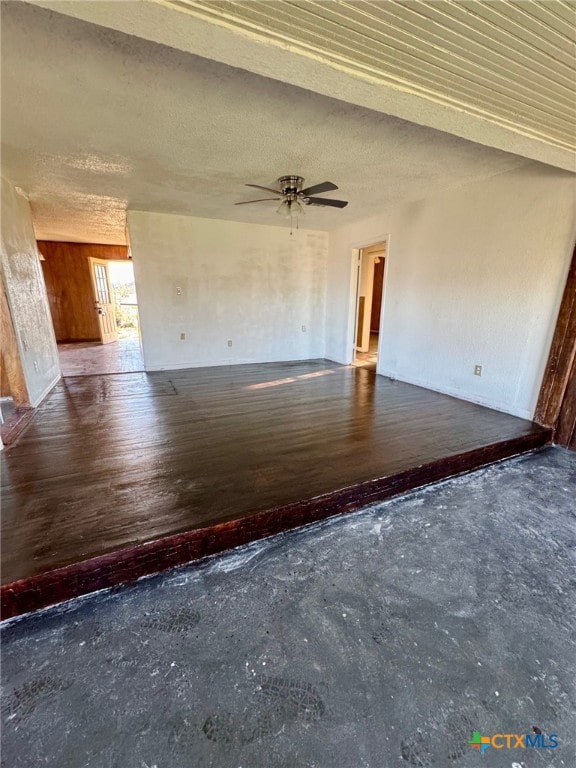 interior space with dark hardwood / wood-style floors and ceiling fan