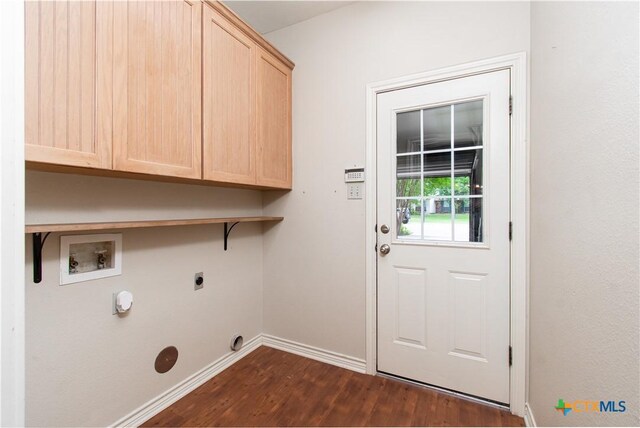 clothes washing area featuring cabinet space, hookup for a washing machine, baseboards, dark wood-type flooring, and hookup for an electric dryer