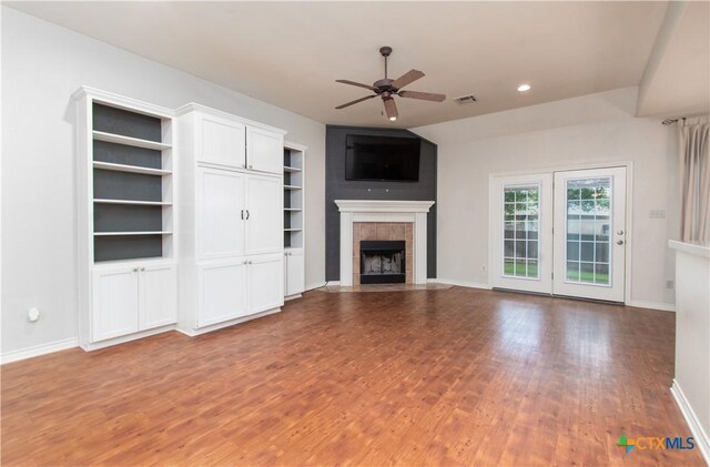 unfurnished living room featuring a fireplace, a ceiling fan, baseboards, recessed lighting, and wood finished floors