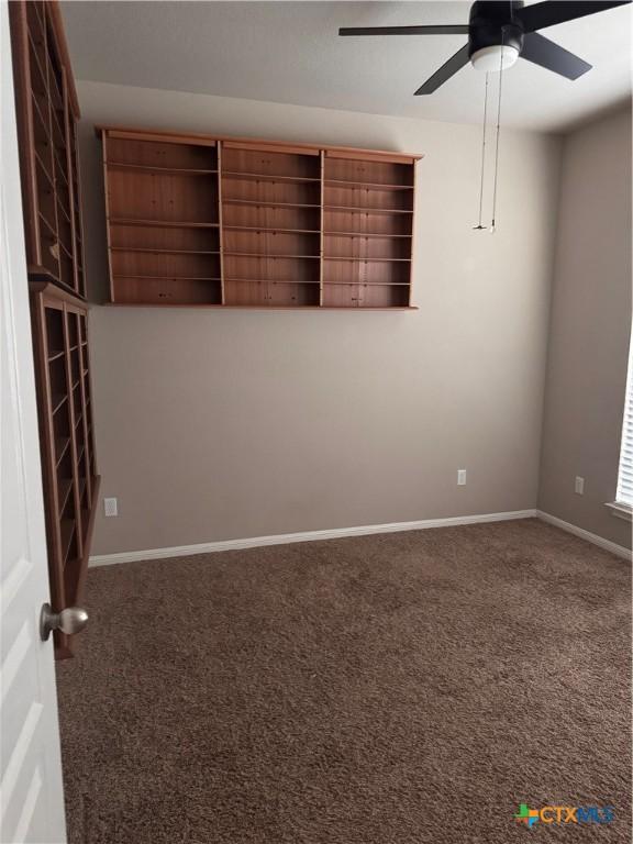 empty room with ceiling fan, baseboards, and carpet floors