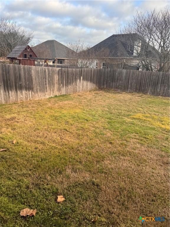 view of yard with a fenced backyard