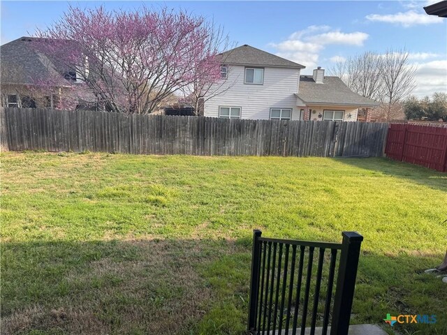 view of yard with a fenced backyard