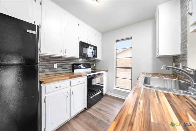 kitchen featuring black appliances, backsplash, sink, light hardwood / wood-style floors, and white cabinets