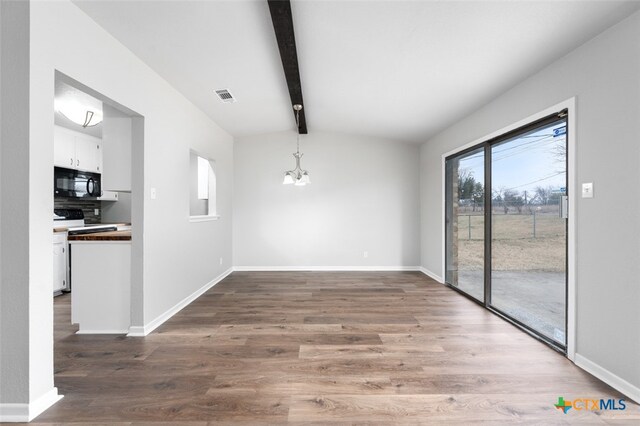 unfurnished dining area with hardwood / wood-style floors, vaulted ceiling with beams, and a notable chandelier