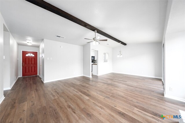 unfurnished living room featuring vaulted ceiling with beams, hardwood / wood-style flooring, and ceiling fan