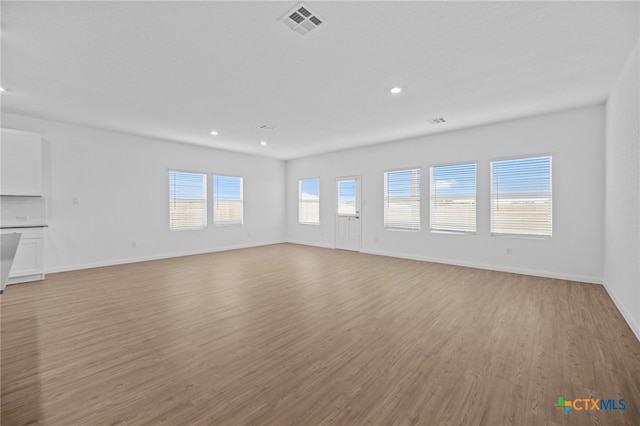 unfurnished living room with light hardwood / wood-style flooring