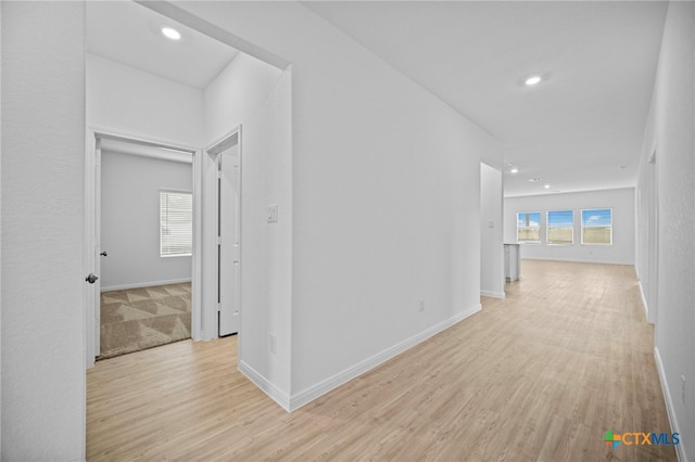 hall featuring light hardwood / wood-style flooring and a wealth of natural light