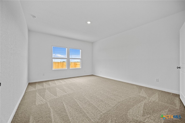 spare room with light colored carpet