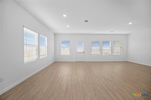 unfurnished living room featuring light hardwood / wood-style floors