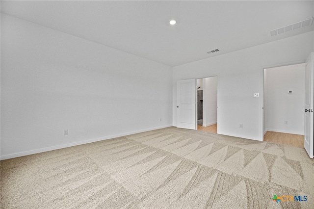 unfurnished bedroom featuring light carpet