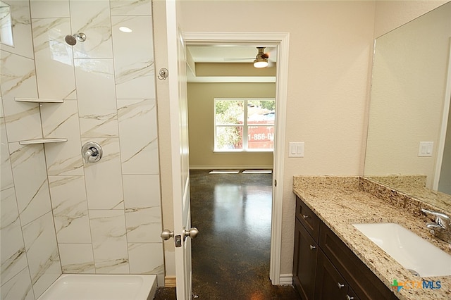 bathroom featuring vanity and a tile shower