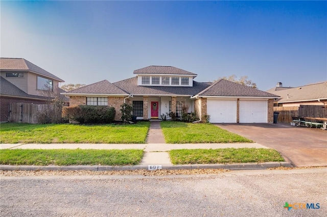 view of front of property featuring fence, an attached garage, concrete driveway, a front lawn, and brick siding