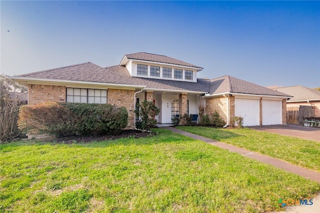 view of front of home featuring a front lawn, concrete driveway, brick siding, and a garage