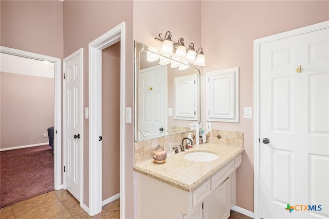 bathroom with tile patterned flooring, vanity, and baseboards